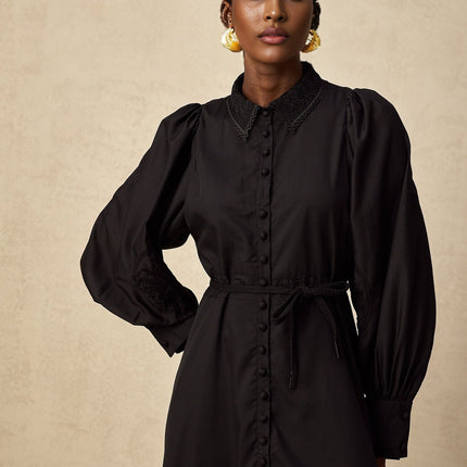 Elegant black midi dress with delicate lace embroidery details and a fitted silhouette