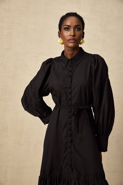 Elegant black midi dress with delicate lace embroidery details and a fitted silhouette