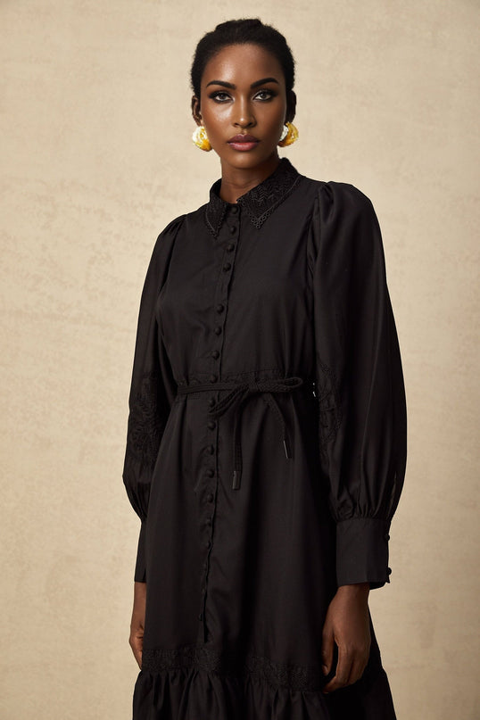 Elegant black midi dress with lace embroidery details and delicate floral patterns throughout