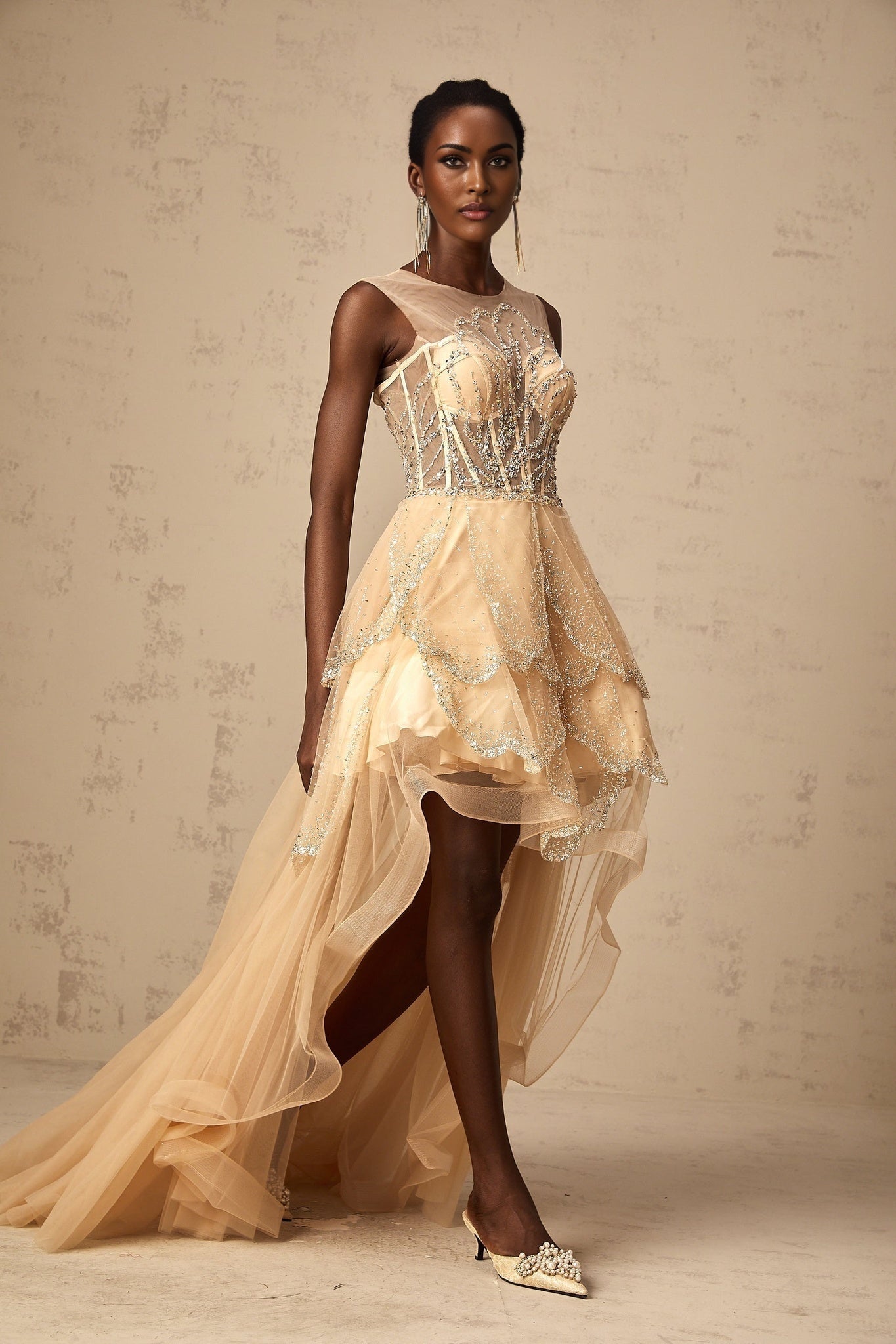 Elegant champagne colored gown with daisy embellishments and high low hemline