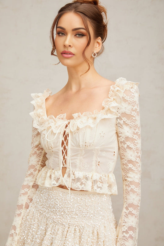 Elegant off white blouse with delicate floral lace pattern and ruffled details