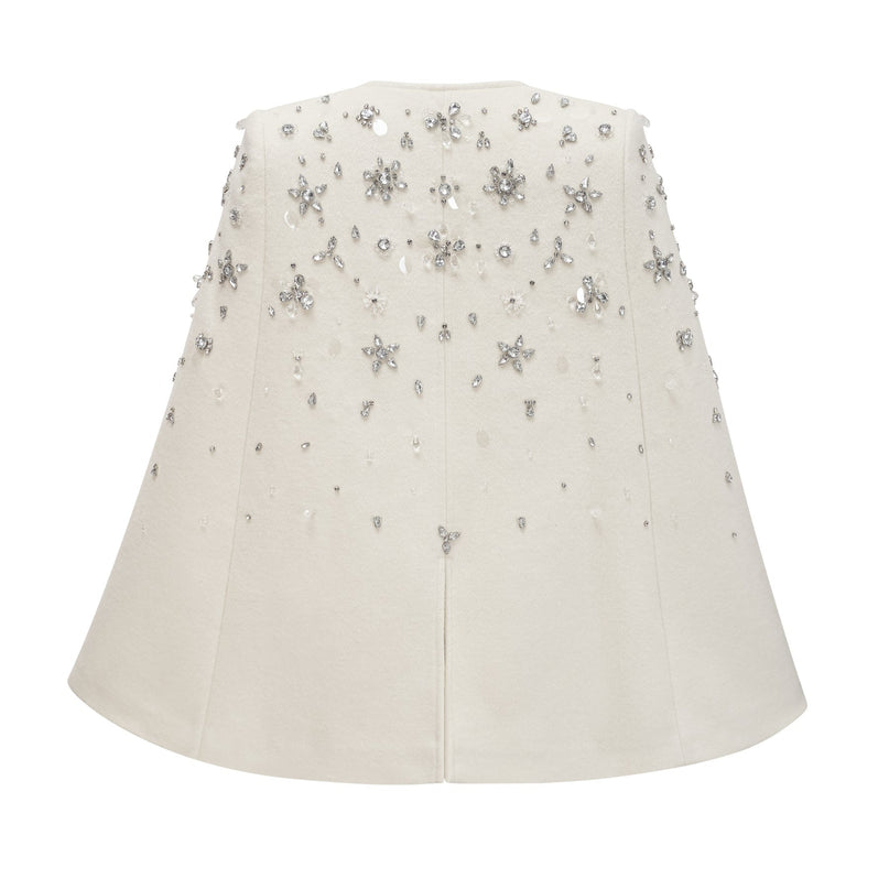 Elegant white jacket with cape design featuring sparkling embellishments and intricate details