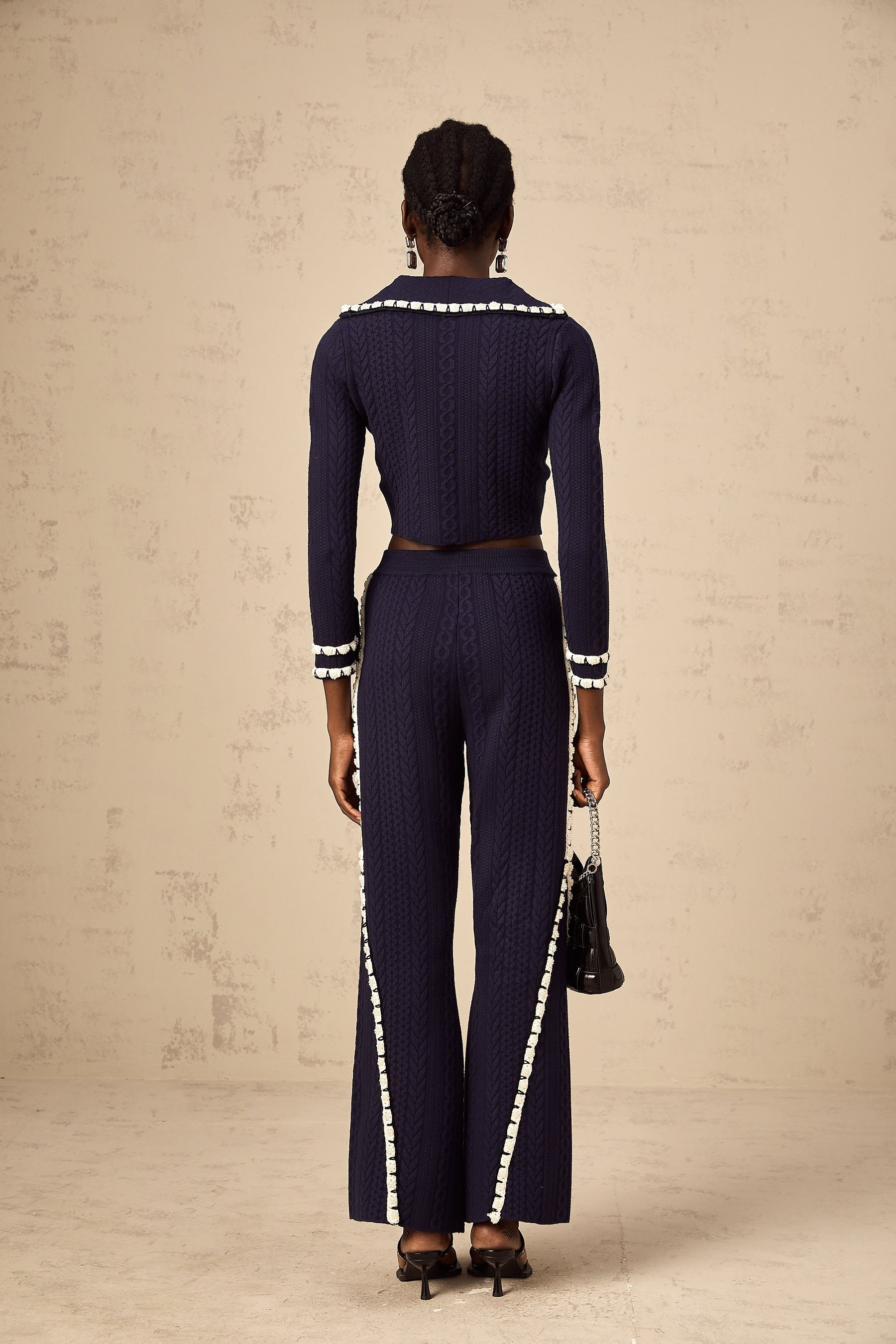Elvira matching set featuring a navy blue crochet knit cardigan and trousers