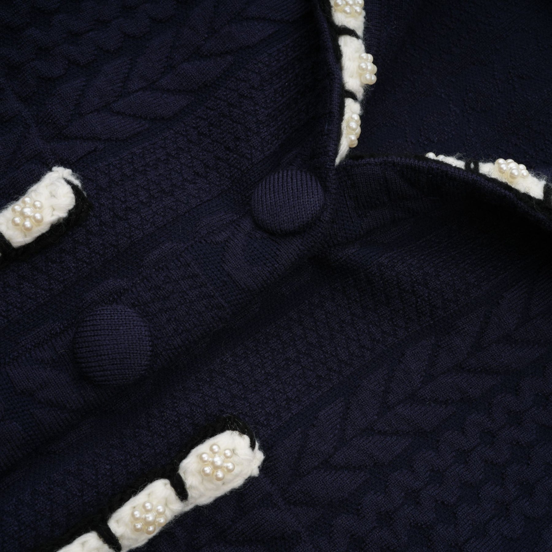 Elvira navy blue crochet knit cardigan and trousers matching set displayed on a plain background