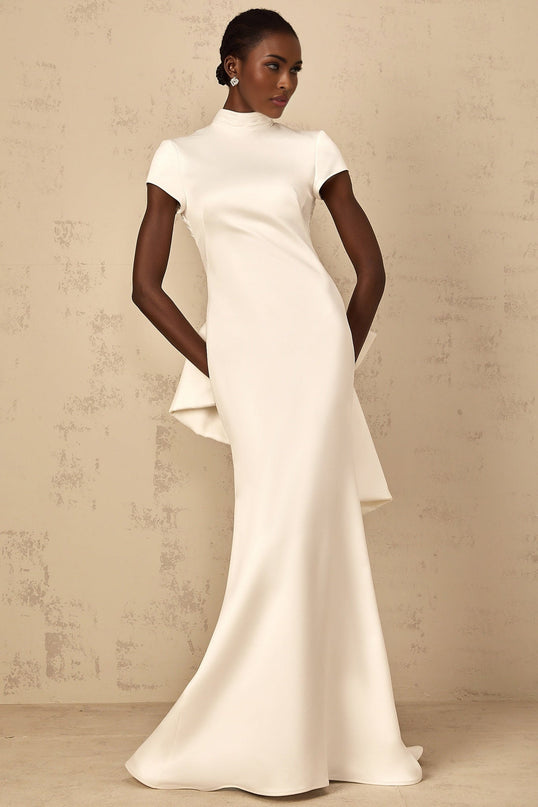 Emanuela White Maxi Dress with Mock Neck Cap Sleeves Open Back Fitted Waistline Boned Bodice Oversize-Bow Mermaid Hem Rear Clasp Zip Fastening 100% Terylene Fiber