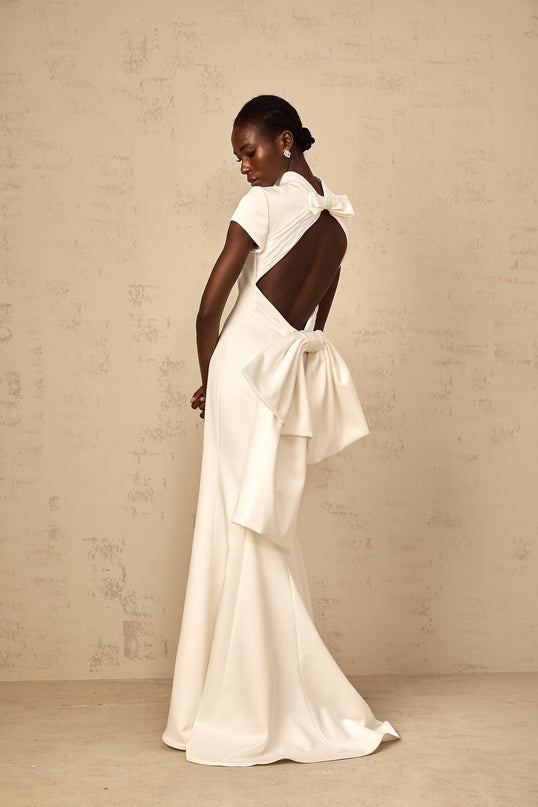 Emanuela White Maxi Dress with Mock Neck Cap Sleeves Open Back Fitted Waistline Boned Bodice Oversize-Bow Mermaid Hem Rear Clasp Zip Fastening 100% Terylene Fiber