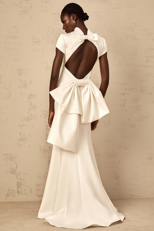Emanuela White Maxi Dress with Mock Neck Cap Sleeves Open Back Fitted Waistline Oversize Bow Mermaid Hem Rear Clasp Zip Fastening 100% Terylene Fiber