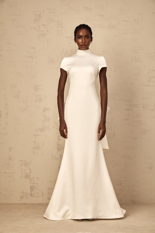 Emanuela White Maxi Dress with Mock Neck Cap Sleeves Open Back Fitted Waistline Boned Bodice Oversize-Bow Mermaid Hem Rear Clasp Zip Fastening 100% Terylene Fiber