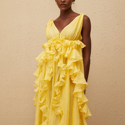 Emilia Yellow Maxi Dress V-neck Sleeveless Open Back Crinkled Ruffled Layered Asymmetrical Hem Fitted Waistline Tassel Detail 100% Terylene Fiber Glamour