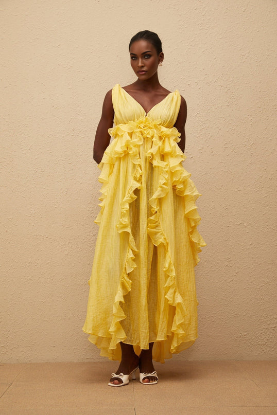 Emilia Yellow Maxi Dress V-neck Sleeveless Open Back Crinkled Ruffled Layered Asymmetrical Hem Fitted Waistline Tassel Detail 100% Terylene Fiber Glamour