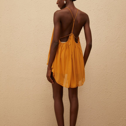 Emily wearing Nemesis Ginger Pleated Chiffon Top in Orange color