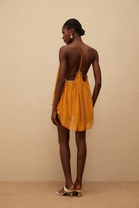 Emily wearing Nemesis Ginger Pleated Chiffon Top in Orange color
