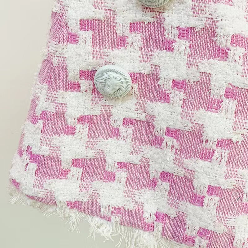 Pink houndstooth double-breasted blazer with silver buttons paired with matching high-waisted shorts