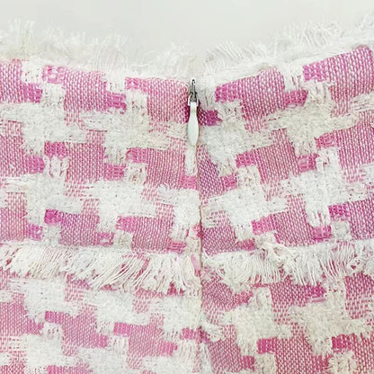 Pink houndstooth double-breasted blazer with silver buttons paired with matching high-waisted shorts