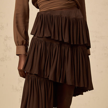 Emma wearing Liora Pleated Tiered Mini Skirt in Brown