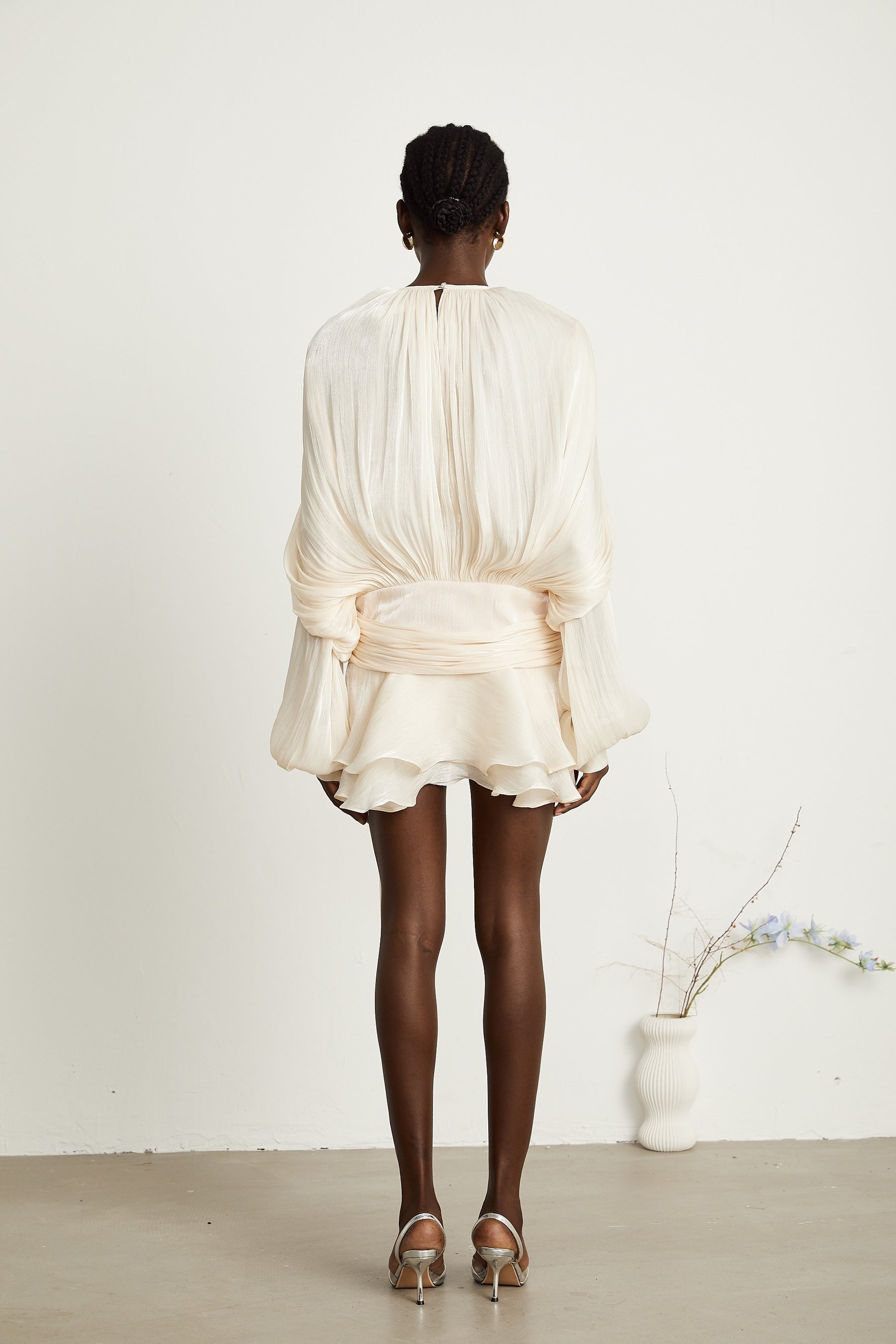 Eugenie neutral colored mini dress with full pleated ruffles and short length