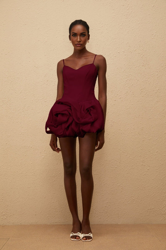 Eulalia Mini Dress in Red with V-neck, spaghetti straps, boned bodice, cinched waist, 3D-petal detailing, bubble skirt, and smocked panel