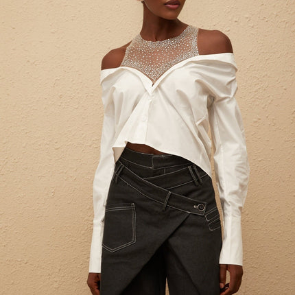 Fiona Shirt in White 100% Cotton Cold Shoulder Mesh Panelling Rhinestone Embellishment Asymmetrical Hem Front Button Fastening Long Sleeves Cropped Silhouette