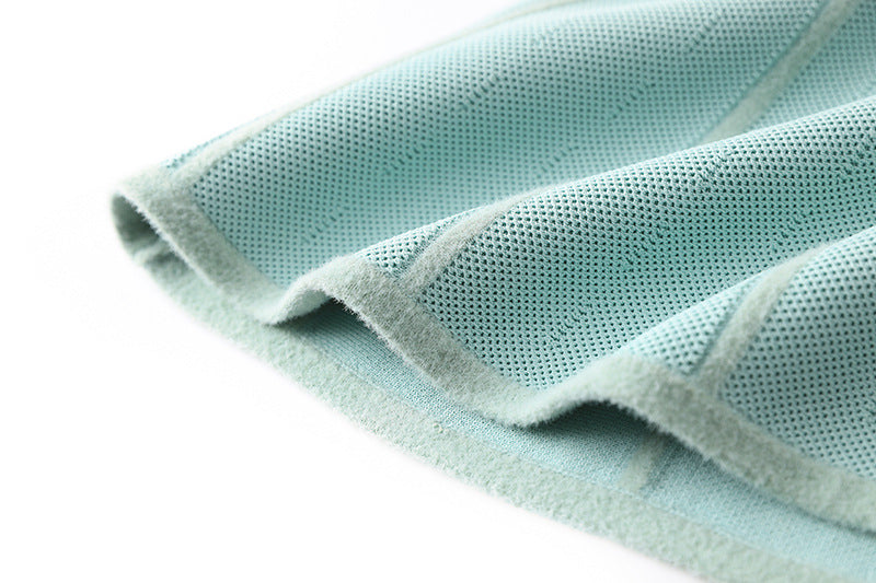 Flared A-line silhouette halter neck style knit dress in soft mint green color with vertical ribbed pattern