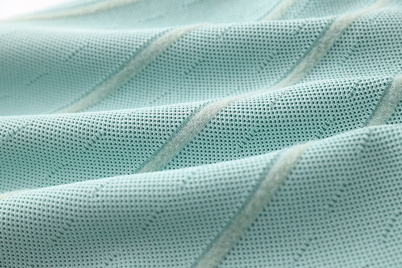 Flared A-line silhouette halter neck style soft mint green knit fabric dress with vertical ribbed pattern