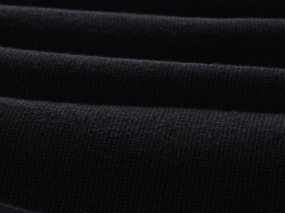 Flared pleated black skirt with gold decorative buttons