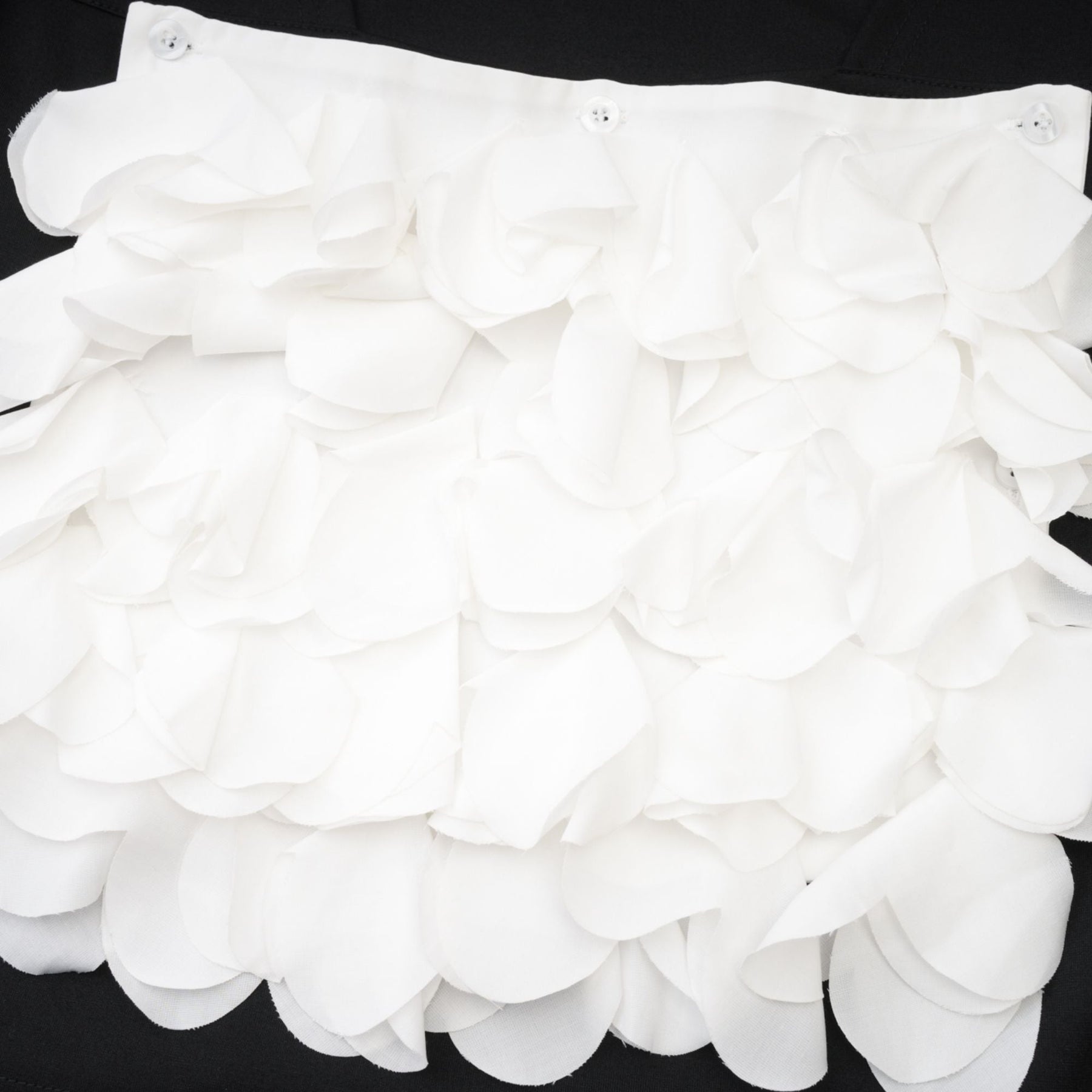 Floral patterned sleeveless top with faux flower embellishments on white background