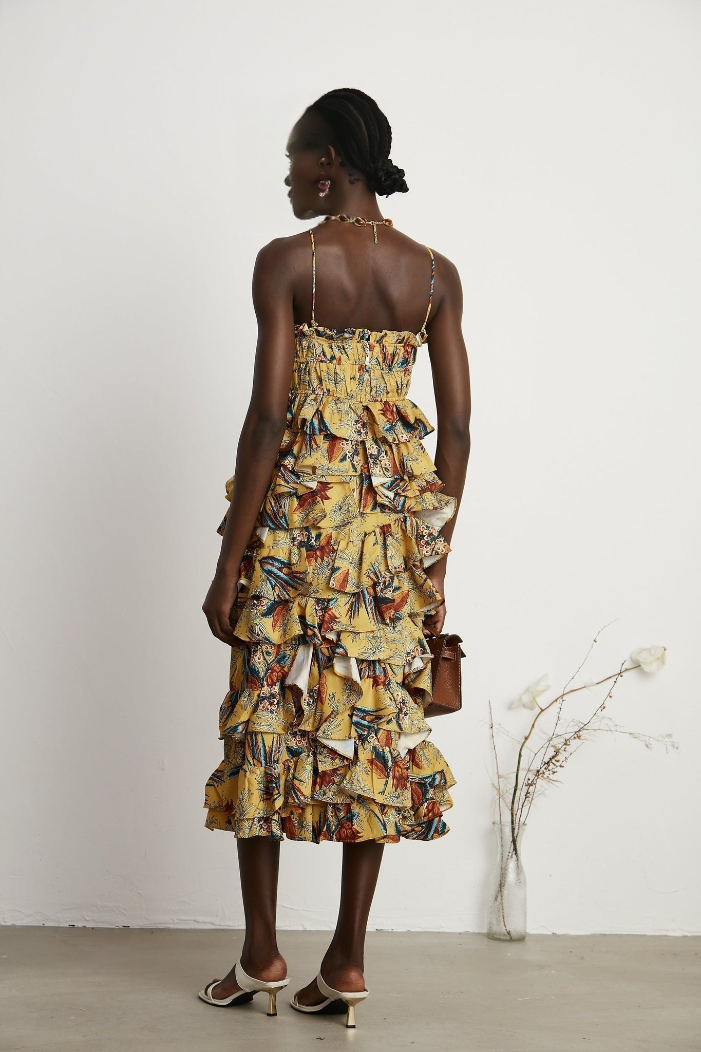Floral print midi dress with tiered ruffles named Apolline on a white background