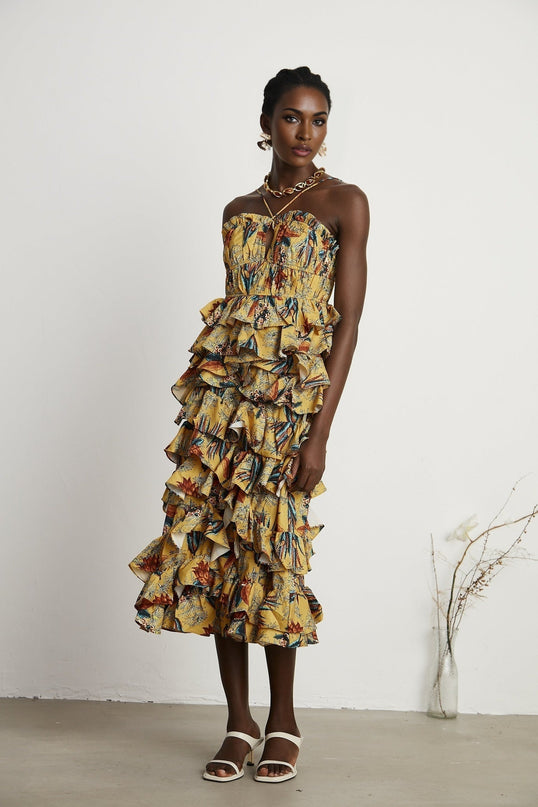 Floral print midi dress with tiered ruffles named Apolline shown on model against plain background