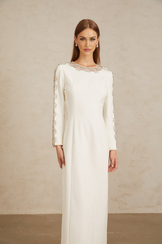 Freja White Crystal Embellished Maxi Gown in pristine white with crystal embellishments and tulle panelling, long sleeves, and rear slit