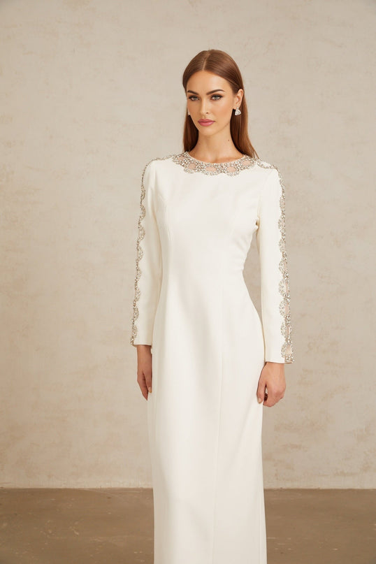 Freja White Crystal Embellished Maxi Gown in pristine white with crystal embellishments and tulle panelling, round neck, long sleeves, fitted waistline, rear slit, and rear zip fastening crafted from 100% Terylene fiber