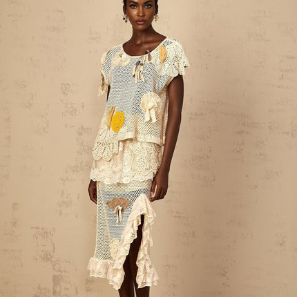 Gelsomina Lace Crochet Skirt in Neutrals high-rise midi skirt with cut-out design and bow detailing