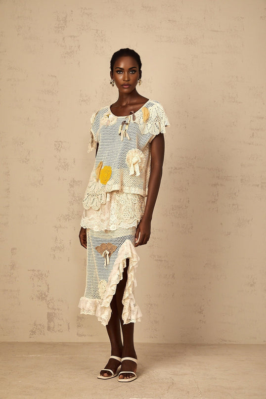 Gelsomina Lace Crochet Skirt in Neutrals high-rise midi skirt with cut-out design and bow detailing