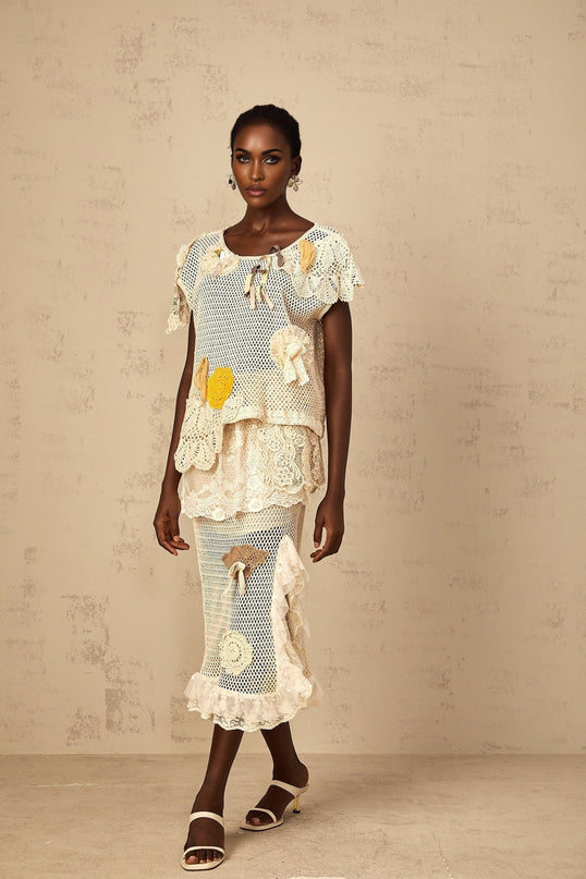 Gelsomina Lace Crochet Skirt in Neutrals high-rise midi skirt with cut-out design and bow detailing