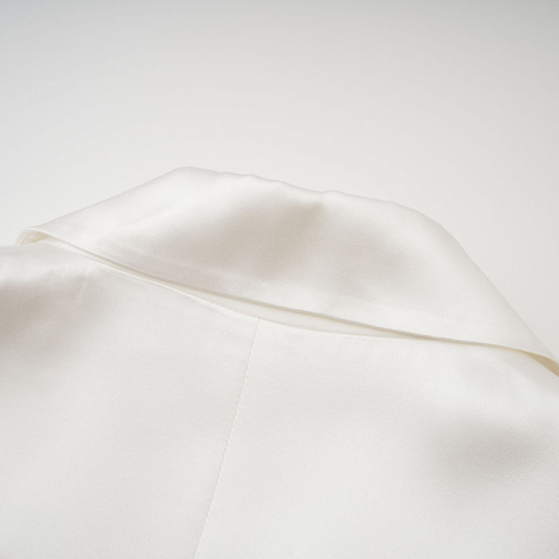 Genesis White Silk Double-Breasted Blazer Notch Lapels Shoulder Pads Buttoned Cuffs Long Sleeves Front Button Closure Front Flap Pockets