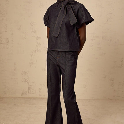 Giuditta Denim Blouse and Jeans Set in Indigo Blue with Ribbon tie-neck detailing, Short puff sleeves, Flared hem, Classic five pockets, Contrast stitching, and 100% Cotton fabric