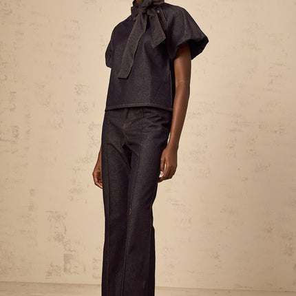 Giuditta Denim Blouse & Jeans Set in Indigo Blue with Ribbon tie-neck detailing, Short puff sleeves, Flared hem, Classic five pockets, and Contrast stitching