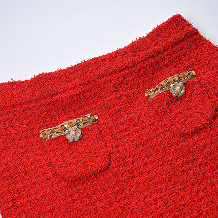 Elegant red tweed jacket with gold embellishments paired with a matching midi skirt, ideal for formal occasions