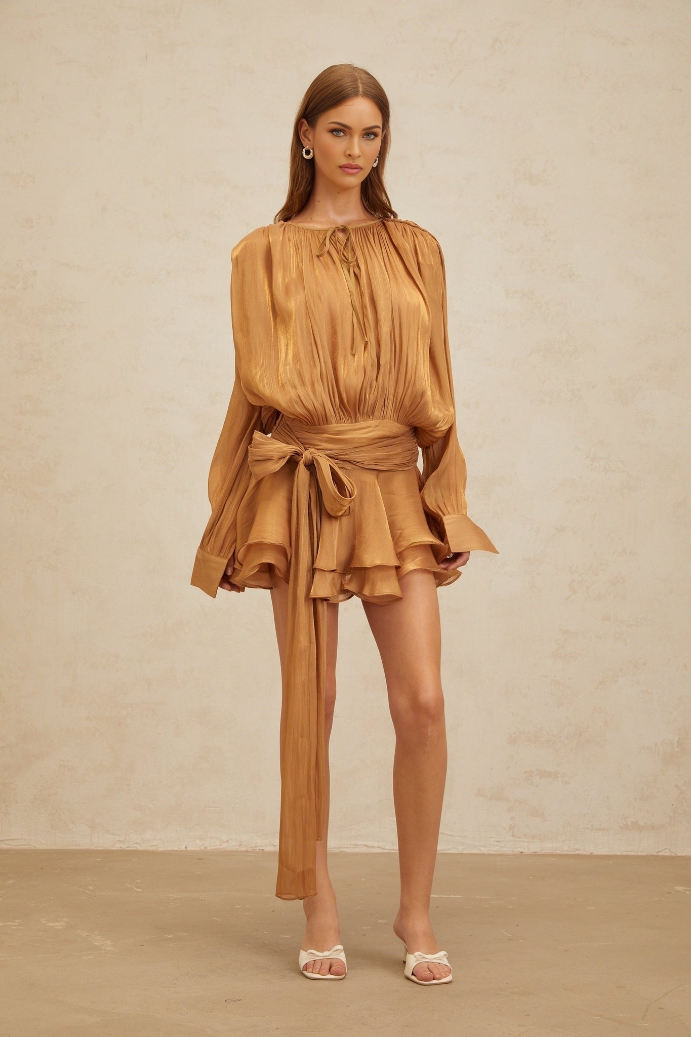 Gold twist design mini dress with ruffled hem and glitter detailing