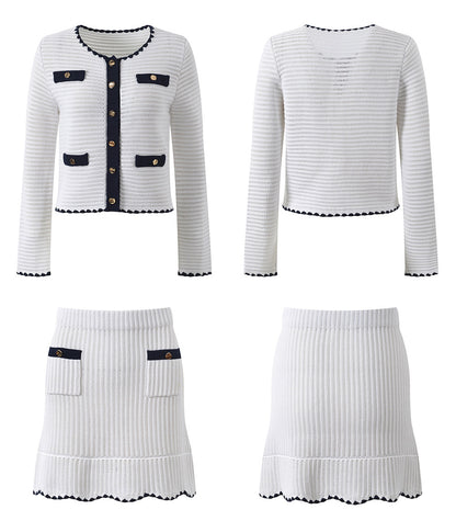 White knit cardigan with navy accents and gold buttons paired with a matching A-line skirt featuring a flared hem