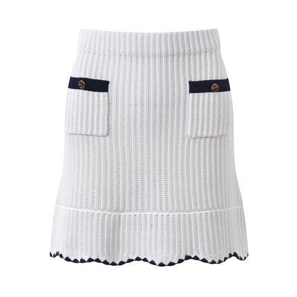White knit cardigan with navy accents and gold buttons paired with a matching A-line skirt featuring a flared hem