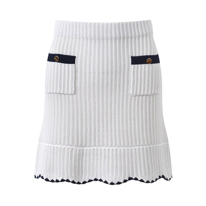 White knit cardigan with navy accents and gold buttons paired with a matching A-line skirt featuring a flared hem