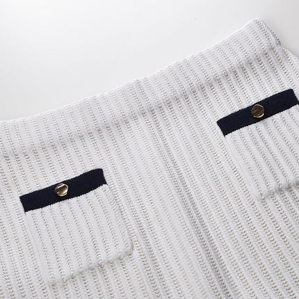 White knit cardigan with navy accents and gold buttons paired with a matching A-line skirt featuring a flared hem