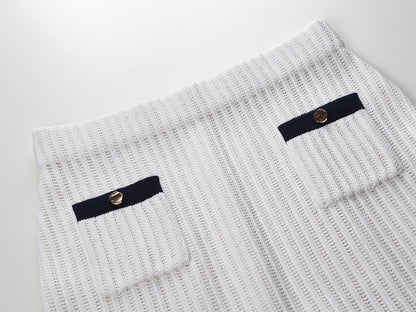 White knit cardigan with navy accents and gold buttons paired with a matching A-line skirt featuring a flared hem