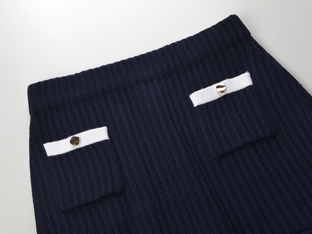 White knit cardigan with navy accents and gold buttons paired with a matching A-line skirt featuring a flared hem