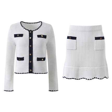White knit cardigan with navy accents and gold buttons paired with a matching A-line skirt featuring a flared hem
