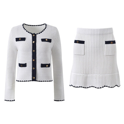 White knit cardigan with navy accents and gold buttons paired with a matching A-line skirt featuring a flared hem