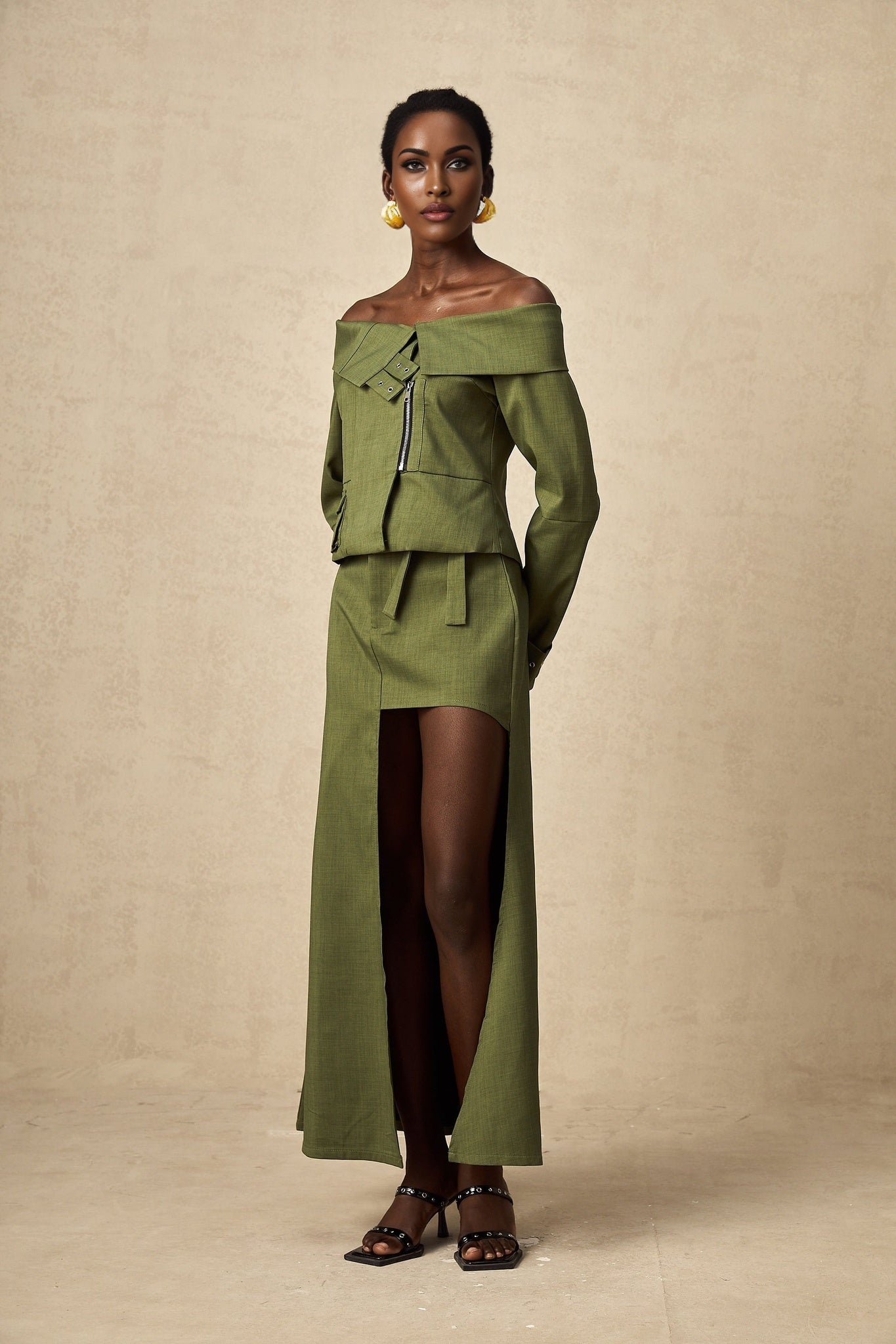 Green asymmetric jacket and skirt set named Elena featuring matching design