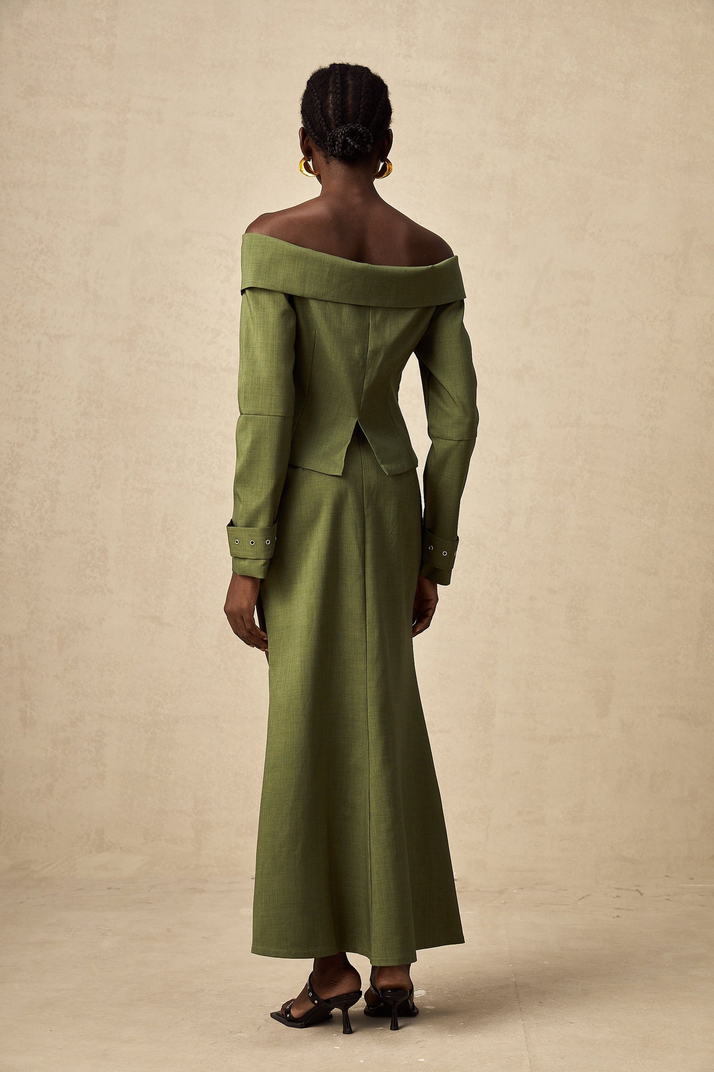 Green asymmetric jacket and skirt set with matching design called Elena
