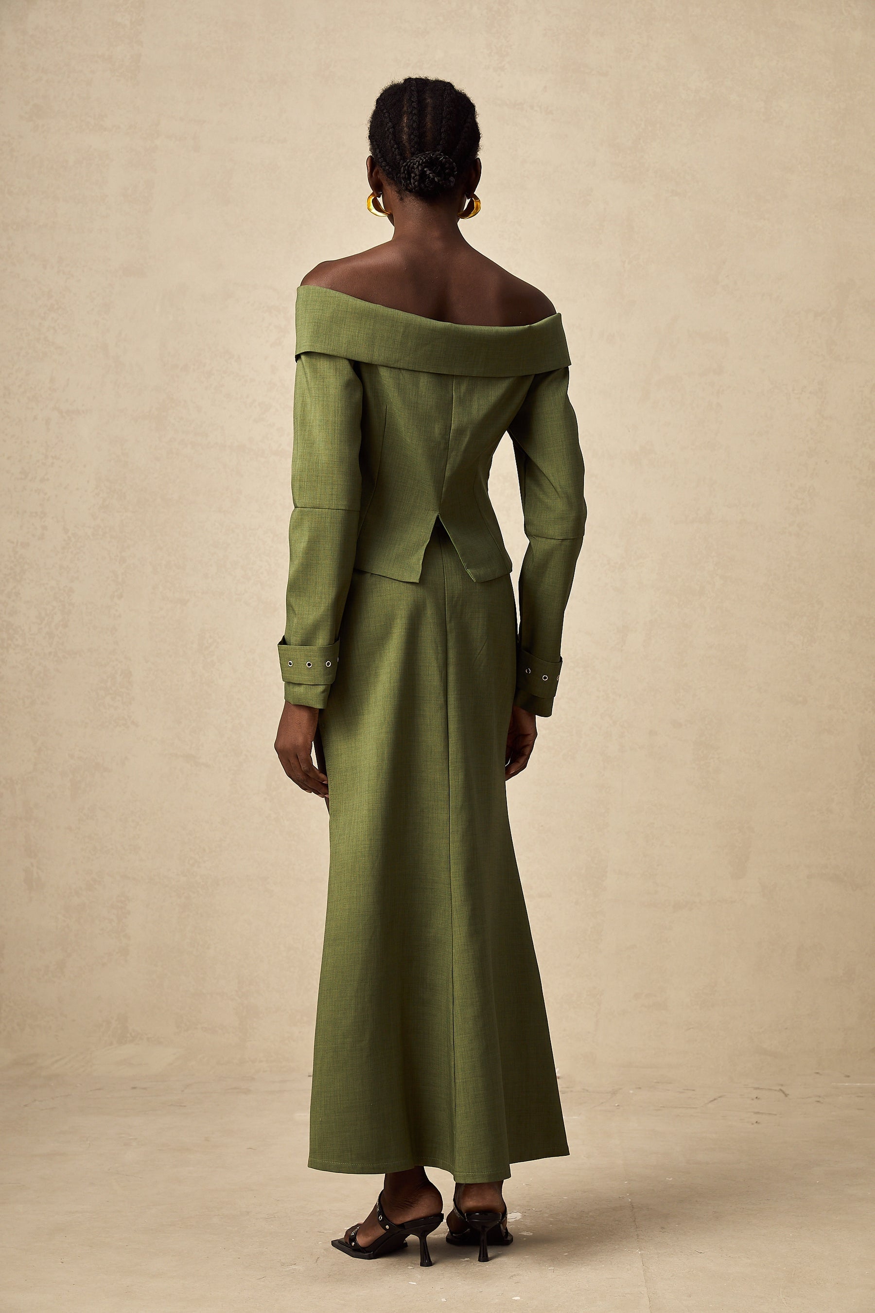 Green asymmetric jacket and skirt set with matching design called Elena