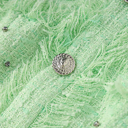 Green halter neck dress with rhinestone accents and frayed edges